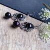 stone earrings for women with black filigree oval pattern 1